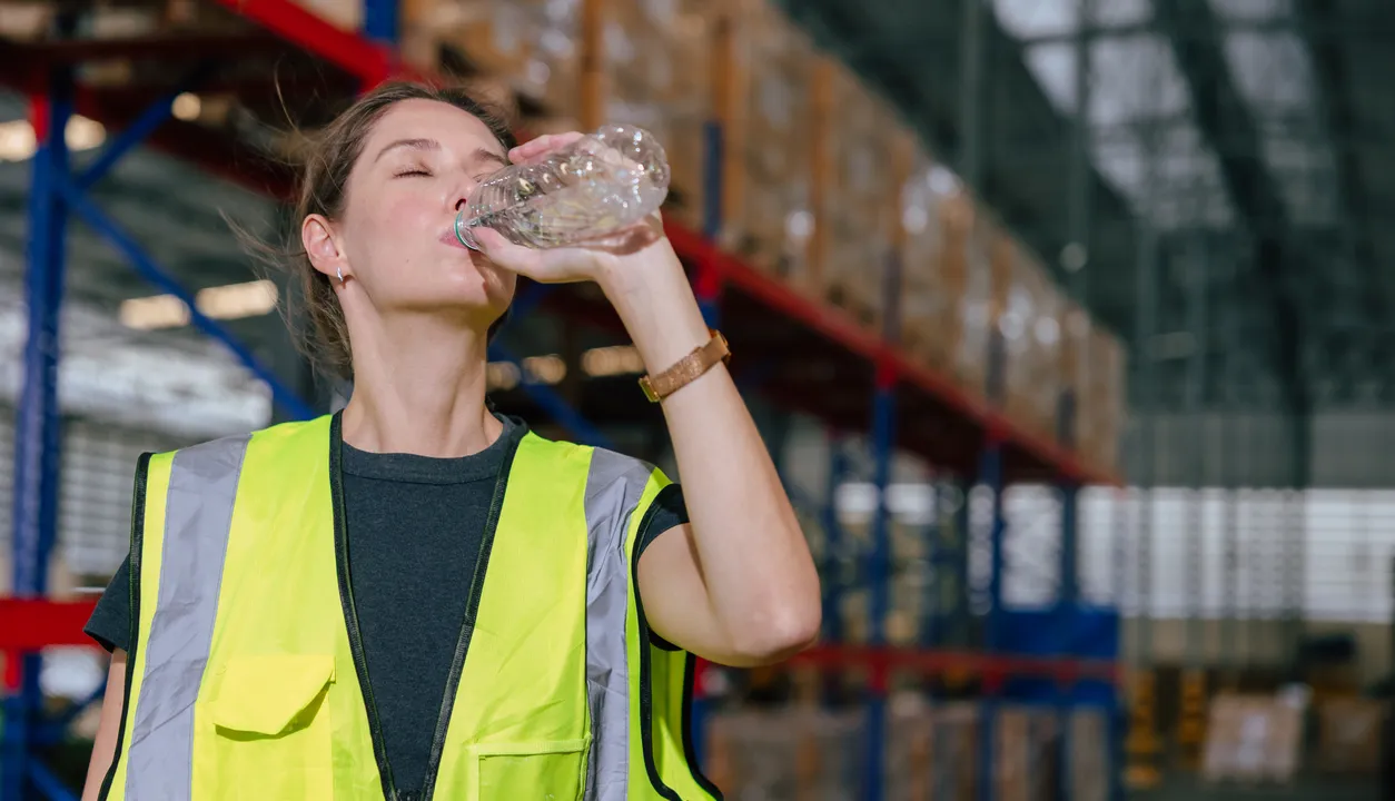 Worker drinking water refresh dehydrate drink cool water chill relax brake in warehouse workplace
